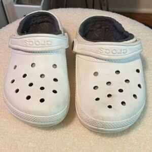 White fuzzy slip on Crocs